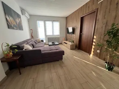 a living room with a couch and a television at Panorama View Belgrade in Belgrade