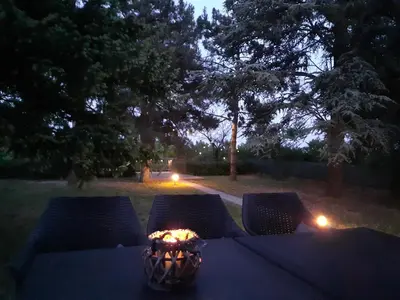 a table with a candle in a vase on it at Belegis Villa in Stari Banovci