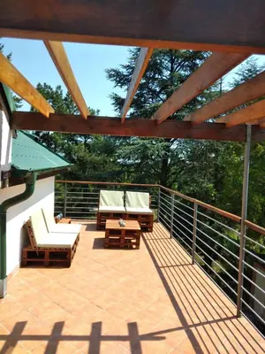 a patio with chairs and tables on a deck at Belegis Villa in Stari Banovci