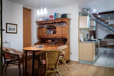 a kitchen and dining room with a table and chairs at Belegis Villa in Stari Banovci