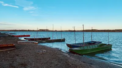 a group of boats sitting on the shore of a lake at Belegis Villa in Stari Banovci