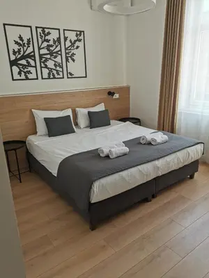 a bedroom with a large bed with two towels on it at Viktor Luxury Suites in Belgrade