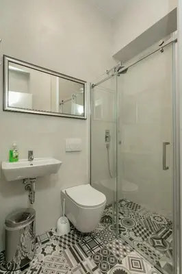 a bathroom with a shower and a toilet and a sink at Viktor Luxury Suites in Belgrade