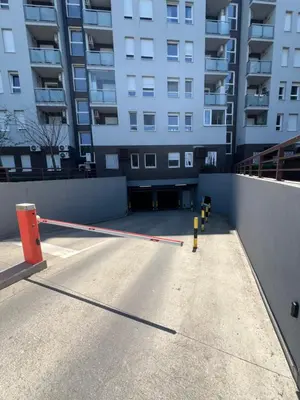 a parking lot with a barrier in front of a building at Hedonia in Belgrade