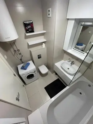 a white bathroom with a toilet and a sink at Hedonia in Belgrade