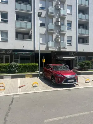 a red car parked in front of a building at Hedonia in Belgrade