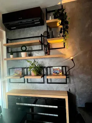 a wall with wooden shelves and plants on it at LUX Apartment A&M Netflix in Belgrade