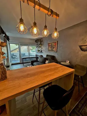 a living room with a wooden table and some lights at LUX Apartment A&M Netflix in Belgrade