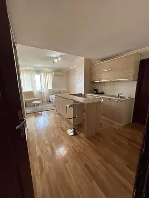 a kitchen with a table and a counter in a room at Apartment Marina in Arandjelovac