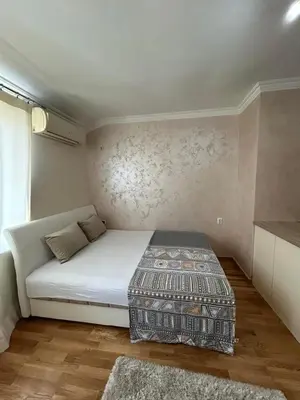 a small bedroom with a white bed and a window at Apartment Marina in Arandjelovac