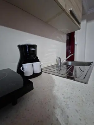 a kitchen counter with a coffee maker and a sink at Apartment Marina in Arandjelovac