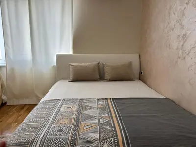 a bed in a small room with a window at Apartment Marina in Arandjelovac