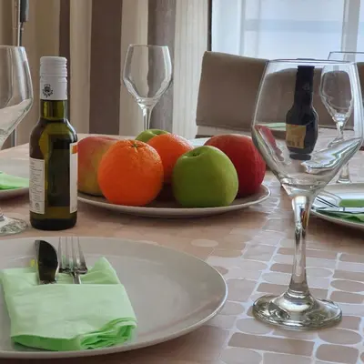 a table with a plate of fruit and wine glasses at Royal apartment Belvill in Belgrade