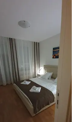 a bedroom with a bed with two towels on it at Royal apartment Belvill in Belgrade