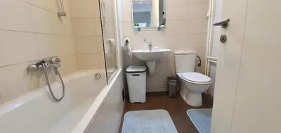 a bathroom with a sink and a toilet and a tub at Royal apartment Belvill in Belgrade