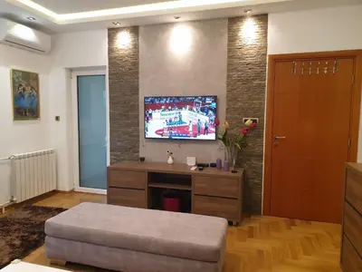 a living room with a flat screen tv on a wall at Metropol Lux apartment Belgrade Vracar in Belgrade