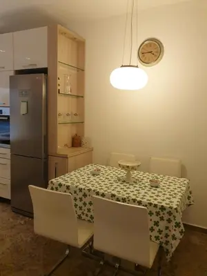 a kitchen with a table and a refrigerator at Metropol Lux apartment Belgrade Vracar in Belgrade