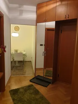 a room with a door and a table with a table at Metropol Lux apartment Belgrade Vracar in Belgrade