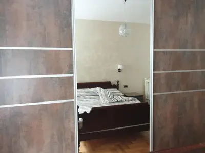 a bedroom with a bed and a mirror in a room at Metropol Lux apartment Belgrade Vracar in Belgrade