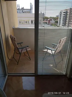 a balcony with a chair sitting on a balcony at Vlado apartment VS in Belgrade