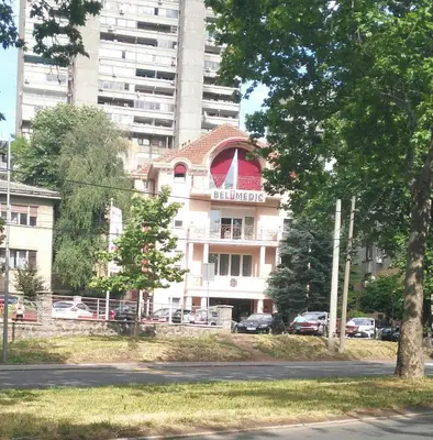 a building with a flag on top of it at Vlado apartment VS in Belgrade