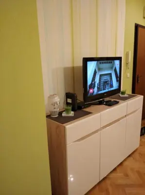 a tv sitting on top of a white dresser at Vlado apartment VS in Belgrade