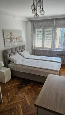 a bedroom with a large bed in a room at Sweet Home in Belgrade