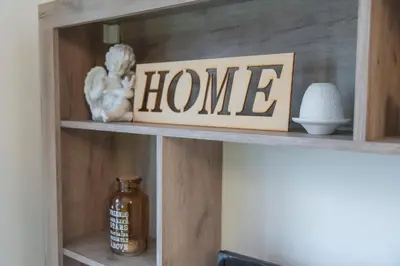 a shelf with a home sign on top of it at Sweet Home in Belgrade