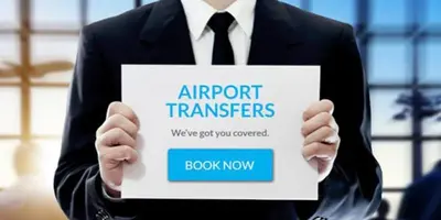 a man in a suit holding a sign that reads airport transfers at Sweet Home in Belgrade