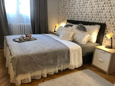 a bedroom with a bed with a tray with teddy bears on it at Vracar Apartment in Belgrade