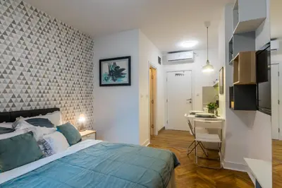 a bedroom with a bed and a desk in a room at Vracar Apartment in Belgrade