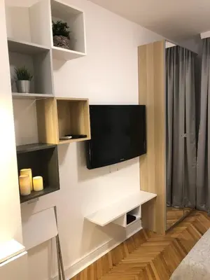a living room with a flat screen tv on a wall at Vracar Apartment in Belgrade