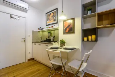 a kitchen with a table and chairs and a sink at Vracar Apartment in Belgrade