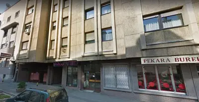 a building with a car parked in front of it at Vracar Apartment in Belgrade