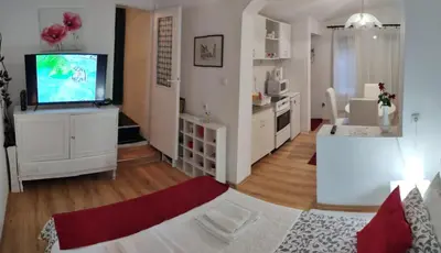 a living room with a flat screen tv and a living room at Gardos dupleks in Belgrade
