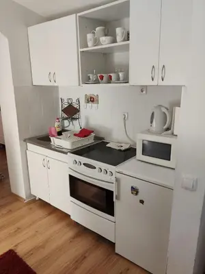 a kitchen with white appliances and white cabinets at Gardos dupleks in Belgrade