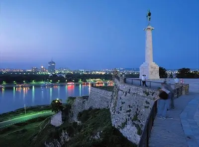 a person standing on a wall near a body of water at Gardos dupleks in Belgrade