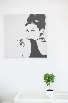 a wall with a decal of a woman holding a cigarette at Slavija Fontana Lux Apartments in Belgrade