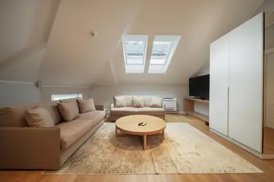 a living room with a couch and a table at Slavija Fontana Lux Apartments in Belgrade
