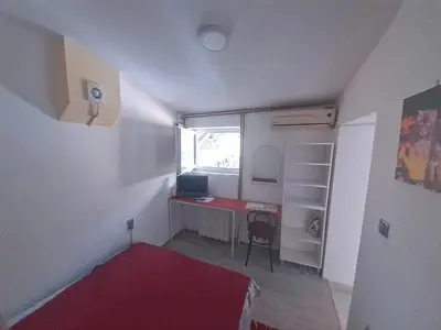 a small room with a desk and a bed and a window at Studio Krunska 6 in Belgrade