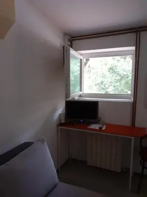 a room with a desk with a computer and a window at Studio Krunska 6 in Belgrade