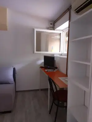 a small room with a desk with a computer and a window at Studio Krunska 6 in Belgrade
