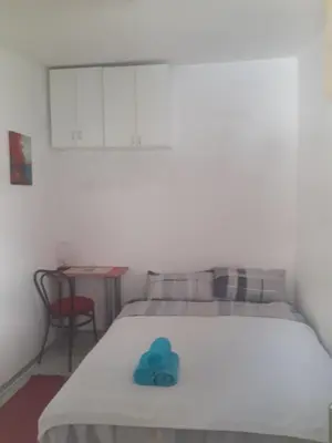 a bedroom with a bed with a blue towel on it at Studio Krunska 6 in Belgrade