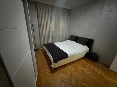 a small bedroom with a bed in a room at Savski Square Suites in Sajmište