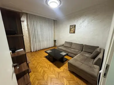 a living room with a couch and a table at Savski Square Suites in Sajmište