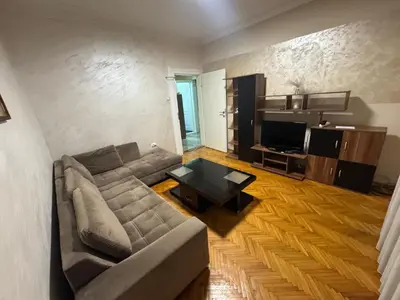 a living room with a couch and a table at Savski Square Suites in Sajmište