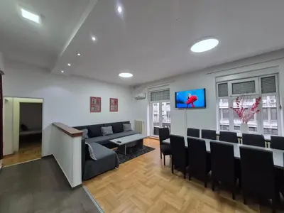 a waiting room with a couch and chairs and a tv at Authentic Belgrade Centre Apartment #2, Four Bedrooms, One full Bathroom, One Toilet in Belgrade