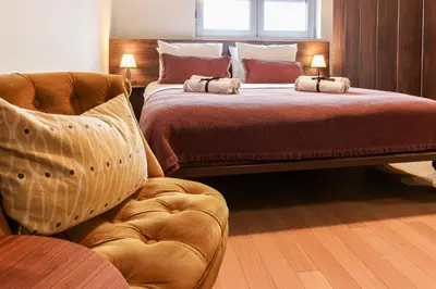 a bedroom with two beds and a chair and a bed at Apartment Story,Nikole Cupica Beograd in Belgrade