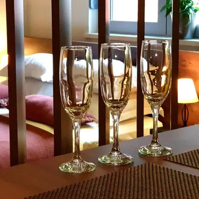 three wine glasses sitting on top of a table at Apartment Story,Nikole Cupica Beograd in Belgrade