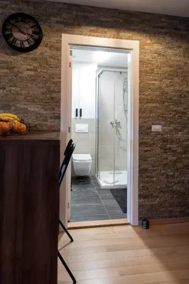 a bathroom with a toilet and a glass shower at Apartment Story,Nikole Cupica Beograd in Belgrade